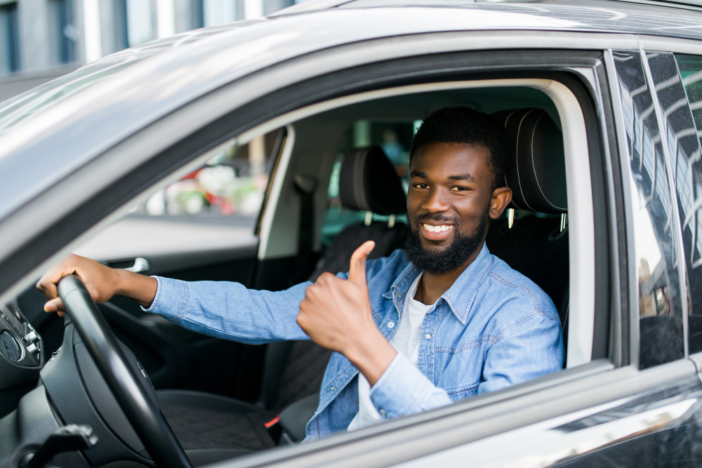 happy-african-businessman-giving-thumb-up-inside-new-car